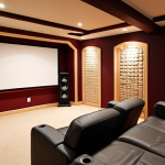 ** A cozy basement home theater setup. Soundproofing materials like acoustic foam panels are visibly installed on the walls. Soft lighting and comfortable seating. Focus on creating a sense of immersion.

**